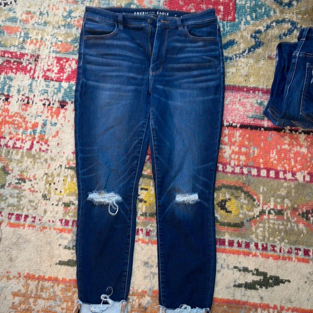 AE next level stretch denim jeans size 14 with distressed knees and raw edge